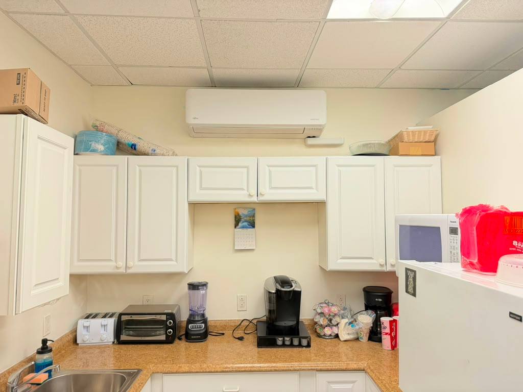 Wall-mounted indoor HVAC unit in a kitchenette